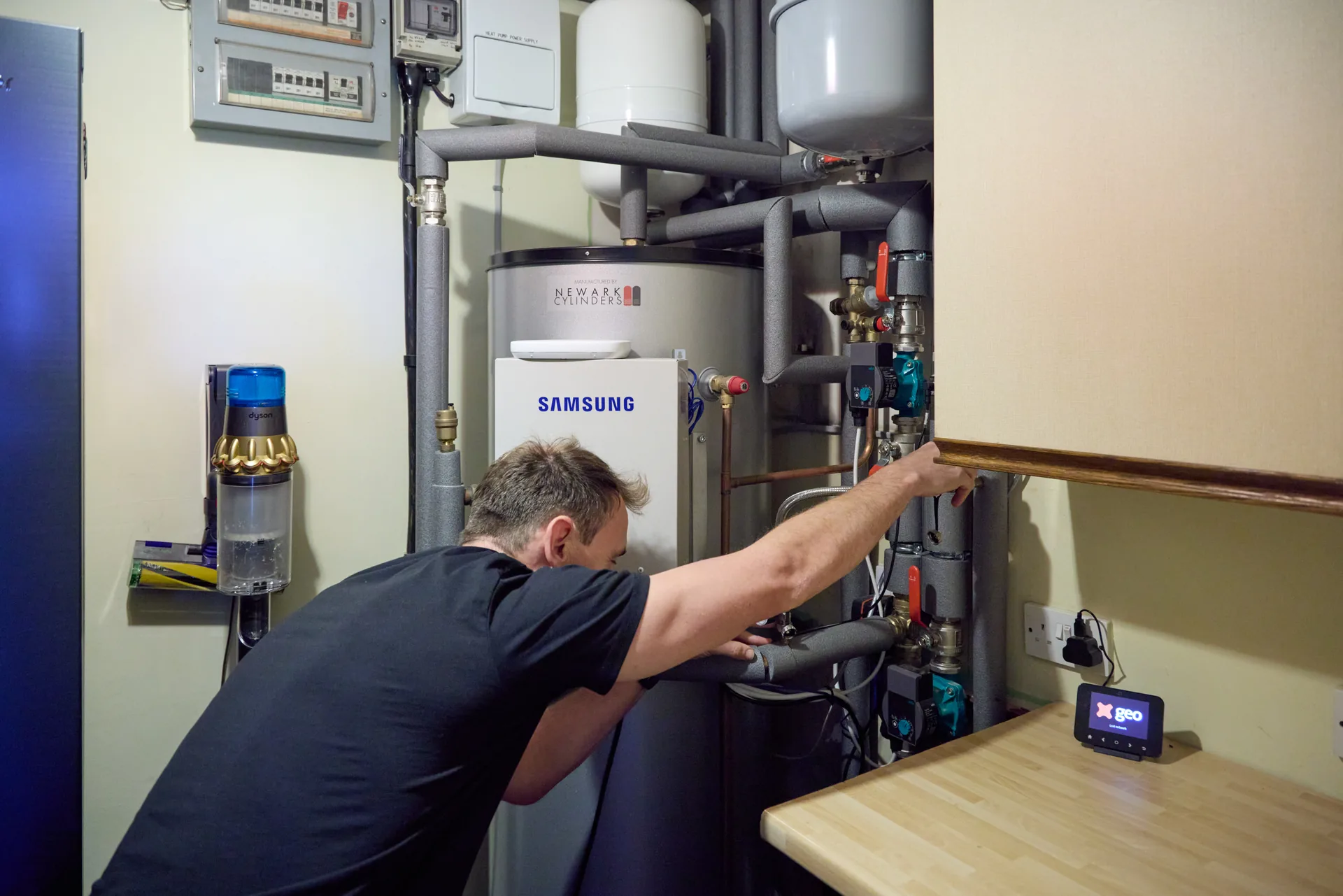 Vector Heat engineer installing a Newark Super Cylinder beside a Samsung wiring centre